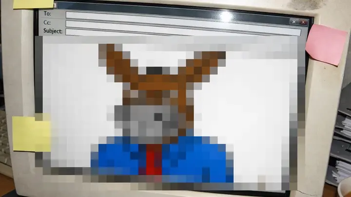 An office monitor showing a drawing censored with a mosaic